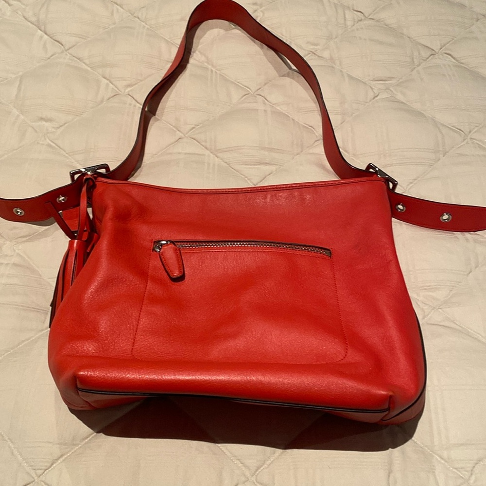 Coach hand bag genuine leather with chrome hardware.